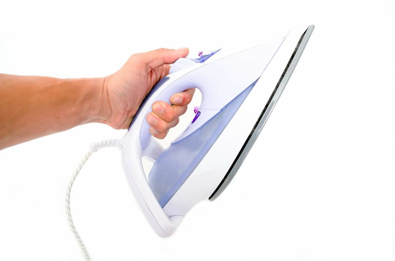 clothes iron in hand