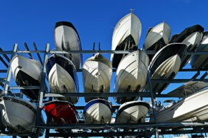 Boats on a storage rack on land.