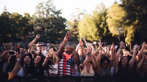 People at a concert on open land.