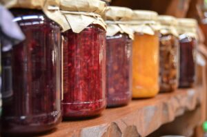 Jars full of jam and jelly on a table.