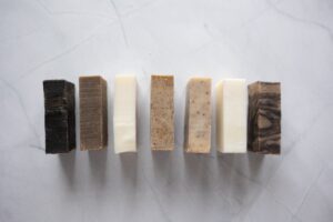 Naturally made soaps against a white marbel background.