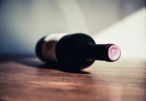 Bottle of wine on a table against a white background.