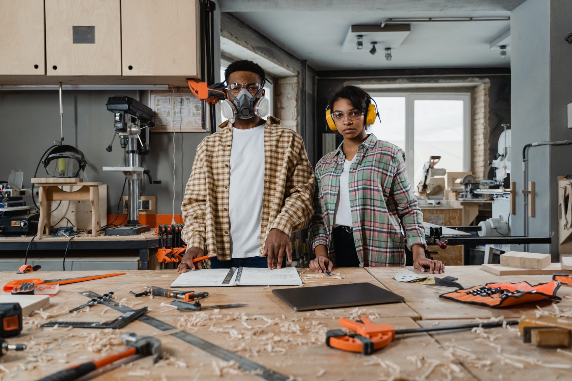 man and woman in woodworking workshop