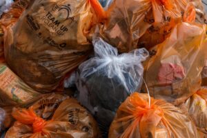 Picture of orange trash bags full of garbage.