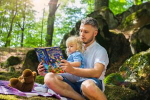 Picture of a father reading to his daughter.