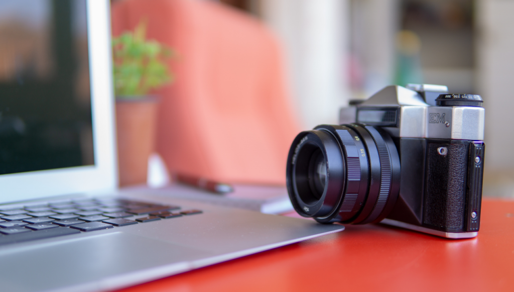 Photography Business Name Idea - a camera next to a laptop on a desk