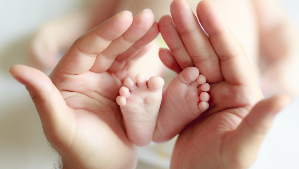 Photography Business Name Idea - hands cradling a newborn's feet