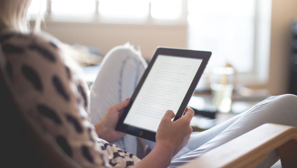 How to Sell Digital Downloads on Amazon - woman reading on an ereader.