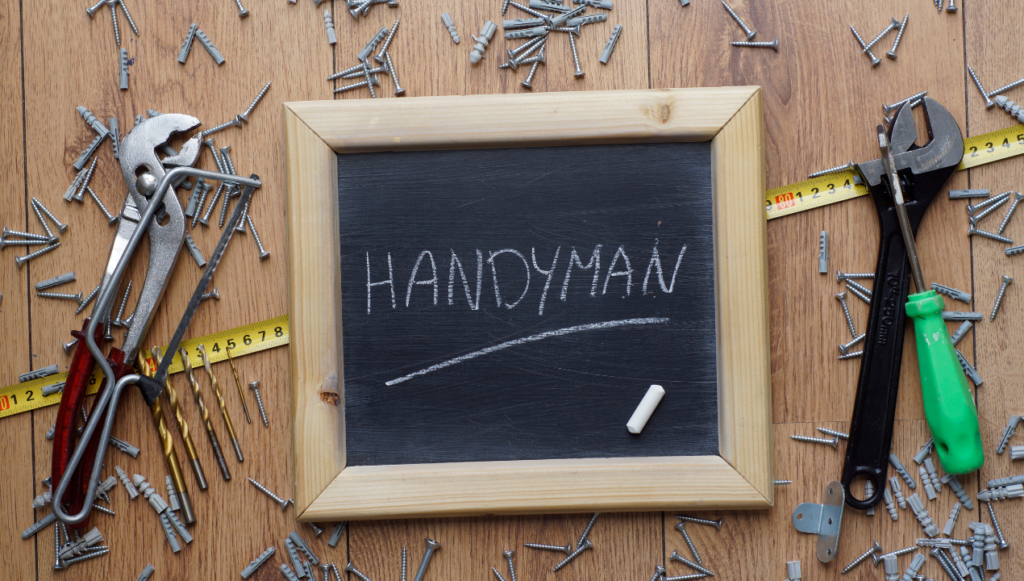 name for handyman business - the word handyman written on a chalkboard surrounded by tools and nails