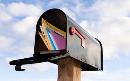 an open mailbox with pieces of colorful mail in it